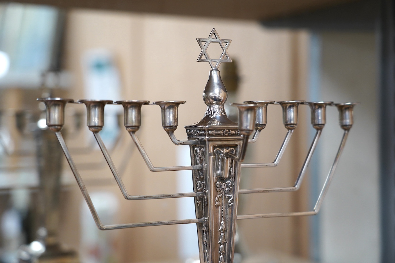 A modern silver Hanukkah Menorah, on a square base with four claw and ball feet, by Alexander Smith, Birmingham, 1967, height 27.6cm, weighted. Condition - fair to good